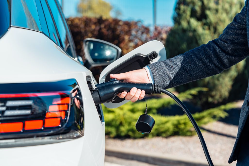 Electric vehicle being connected to a home charging cable.